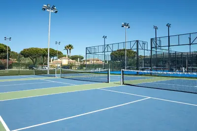 a tennis court with two tennis nets on it at Browns Sports Resort in Vilamoura