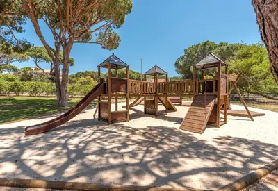 a playground with a slide in a park at Browns Sports Resort in Vilamoura