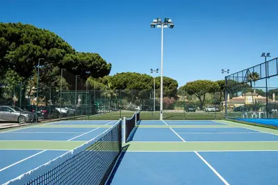 a tennis court with a net on a court at Browns Sports Resort in Vilamoura