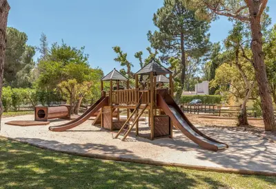 a playground with a slide in a park at Browns Sports Resort in Vilamoura