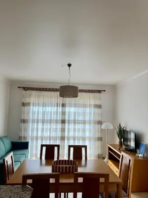 a hotel room with two beds and a lamp at Albufeira Mar Vilas in Albufeira