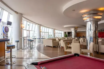 a pool table in a room with tables and chairs at Hotel Apartamento Paraiso De Albufeira in Albufeira