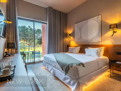 a bedroom with a bed and a large window at Aqua Pedra Dos Bicos Design Beach Hotel - Adults Friendly in Albufeira