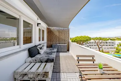 a balcony with a bench and a table at Beautiful Rooftop, Vilamoura in Quarteira