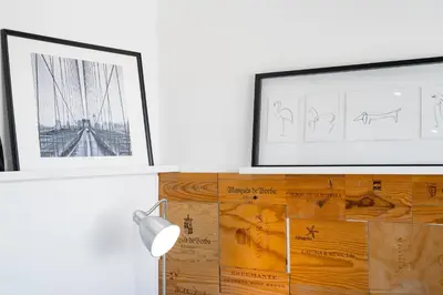 a room with two pictures on the wall and a lamp at Beautiful Rooftop, Vilamoura in Quarteira