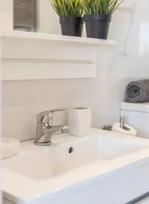 a white sink with two cups on top of it at Beautiful Rooftop, Vilamoura in Quarteira