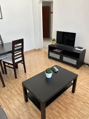 a living room with a black coffee table and a tv at Brother´s House in Faro