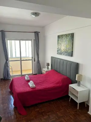 a bedroom with a red bed with a red blanket at Brother´s House in Faro
