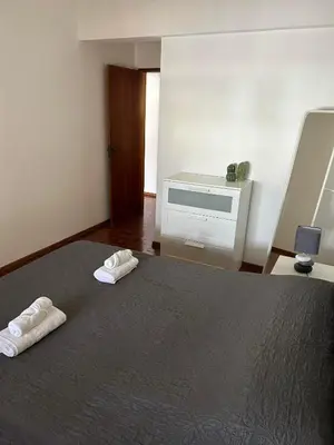 a bedroom with a bed with two towels on it at Brother´s House in Faro