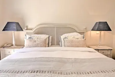 a bedroom with a white bed with two lamps at Quinta Jacintina - My Secret Garden Hotel in Vale do Lobo