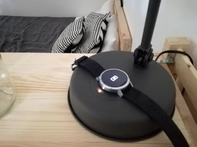 a device with a watch on top of a table at Modern Pool Apartment, Vilamoura in Quarteira