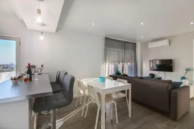 a living room with a couch and a table at Maria Rita Faro Rooftop Apartment in Faro