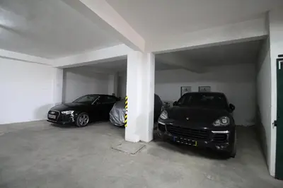 two cars are parked in a garage at magnifique appartement sur la plage ... in Albufeira