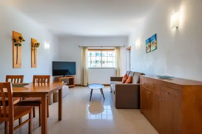 a living room with a couch and a table at Apartamentos Monte da Vinha I in Albufeira