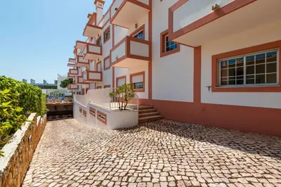 a building with a potted plant on the side of it at Apartamentos Monte da Vinha I in Albufeira