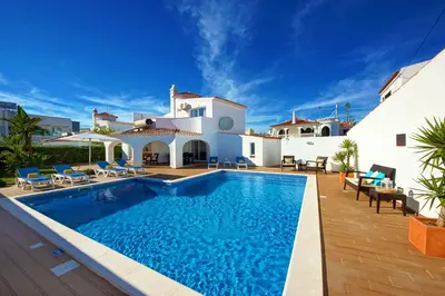 a villa with a swimming pool in front of a house at Villa Francella- Relaxing holidays in an ideal location by DreamvillasAlbufeira in Albufeira