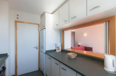 a kitchen with a counter with a large mirror at Residence Golf Club by Garvetur in Vilamoura