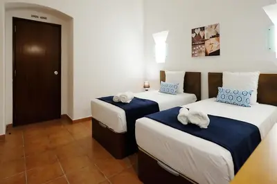 a bedroom with two beds with towels on them at LOTUS VILLA, Albufeira in Albufeira