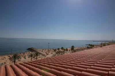 a view of a beach with people and the ocean at Charming Apartment in Quarteira - 50 m² - Terrace in Quarteira