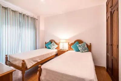 a bedroom with two beds and a window at Charming Apartment in Quarteira - 50 m² - Terrace in Quarteira