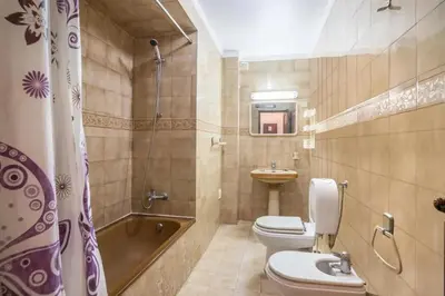a bathroom with a tub and a toilet and a sink at Charming Apartment in Quarteira - 50 m² - Terrace in Quarteira