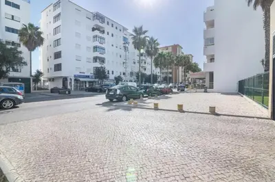 a street with cars parked on the side of a building at Charming Apartment in Quarteira - 50 m² - Terrace in Quarteira