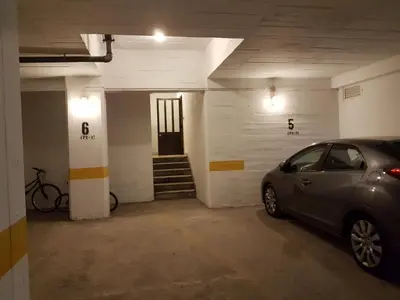 a parking garage with a car parked in it at Apartment Girasol Front Beach Quarteira Algarve in Quarteira