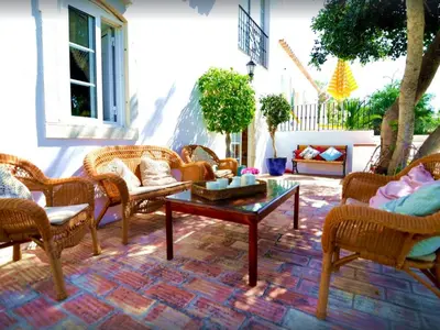 a patio with wicker chairs and a coffee table at Quinta Da Ilda in Loulé