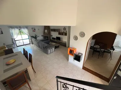 a house with a pool and chairs and an umbrella at Quinta Vita - Vila Uva in Almancil