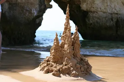 a sand castle on the beach near the ocean at Spacious apartment in Albufeira 80 m² with shared pool in Roja- Pé