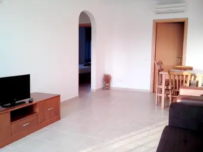 a living room with a tv and a couch at Spacious apartment in Albufeira 80 m² with shared pool in Roja- Pé