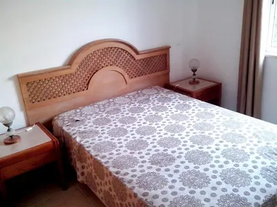 a bedroom with a bed and two end tables at Welcoming apartment in Albufeira 60 m² with shared pool in Albufeira