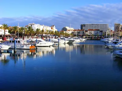 a group of boats docked in a marina with buildings at Charming apartment with shared pool in Albufeira - 60 m² in Albufeira