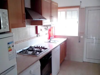 a small kitchen with a stove and a sink at Charming Apartment in Albufeira - 60 m² with pool & view in Albufeira