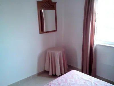 a bedroom with a table and a mirror on the wall at Charming Apartment in Albufeira - 60 m² with pool & view in Albufeira