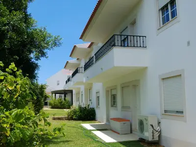 a white building with a balcony on the side at Charming Apartment in Albufeira - 60 m² with pool & view in Albufeira