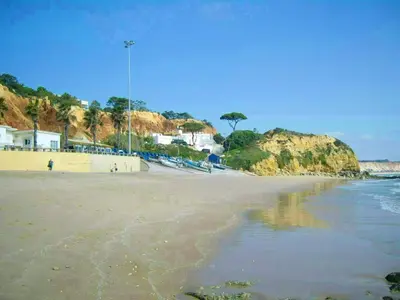 a view of a beach with houses and the ocean at Charming Apartment in Albufeira - 60 m² with pool & view in Albufeira