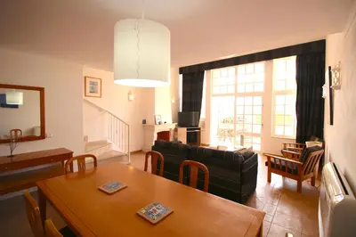 a living room with a couch and a table at magnifique maison en resort près des plages in Albufeira