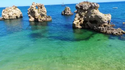 a group of large rocks in the water at magnifique maison en resort près des plages in Albufeira