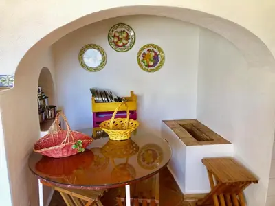 a dining room with a table and plates on the wall at FARMHOUSE CASA DA AVÓ in Loulé