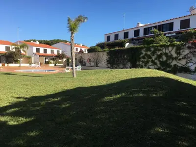 a shadow of a palm tree on a lawn at Casa da Bia in Quarteira