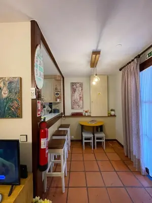 a room with a table and chairs and a fire hydrant at Casa da Bia in Quarteira
