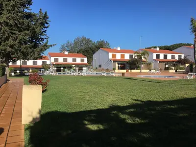 a view of a yard with houses and a park at Casa da Bia in Quarteira