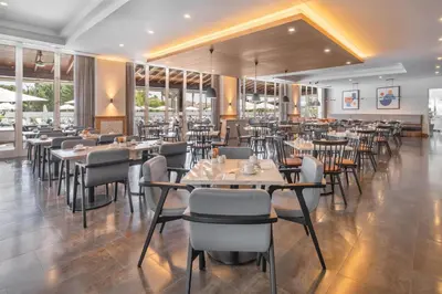 a banquet hall with tables and chairs and umbrellas at Wyndham Grand Algarve in Quinta do Lago