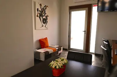 a restaurant with tables and chairs and a large painting on the wall at Lost & Found - Guesthouse & Suites in Albufeira