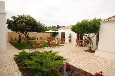 a group of chairs sitting on a balcony at Lost & Found - Guesthouse & Suites in Albufeira