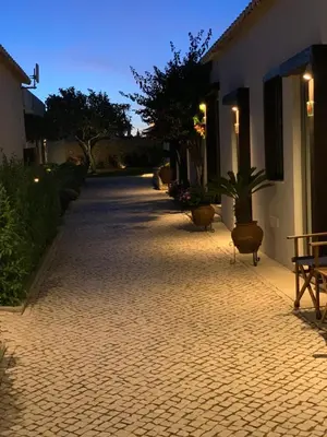 a room with three bunk beds and a desk at Lost & Found - Guesthouse & Suites in Albufeira