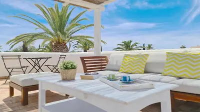 a living room with a white couch and a table at Aldeia do Golf 151 - Clever Details in Vilamoura
