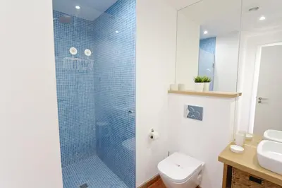 a bathroom with a shower and a toilet and a sink at Aldeia do Golf 151 - Clever Details in Vilamoura