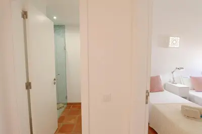 a white room with a bed and a bathroom at Aldeia do Golf 151 - Clever Details in Vilamoura